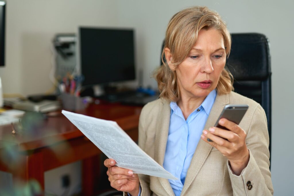 Manager reading a document while on a phone call