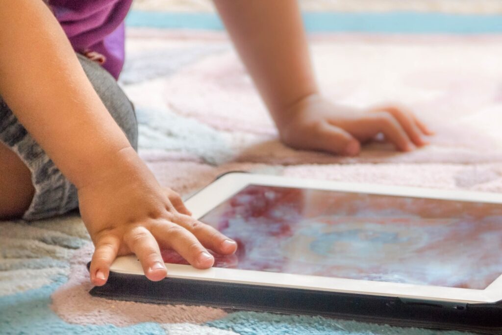Close-up of a young child's hands using a tablet